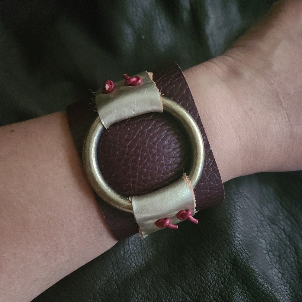NWOT leather cuff bracelet, with leather strings and brass ring. Wearable art!